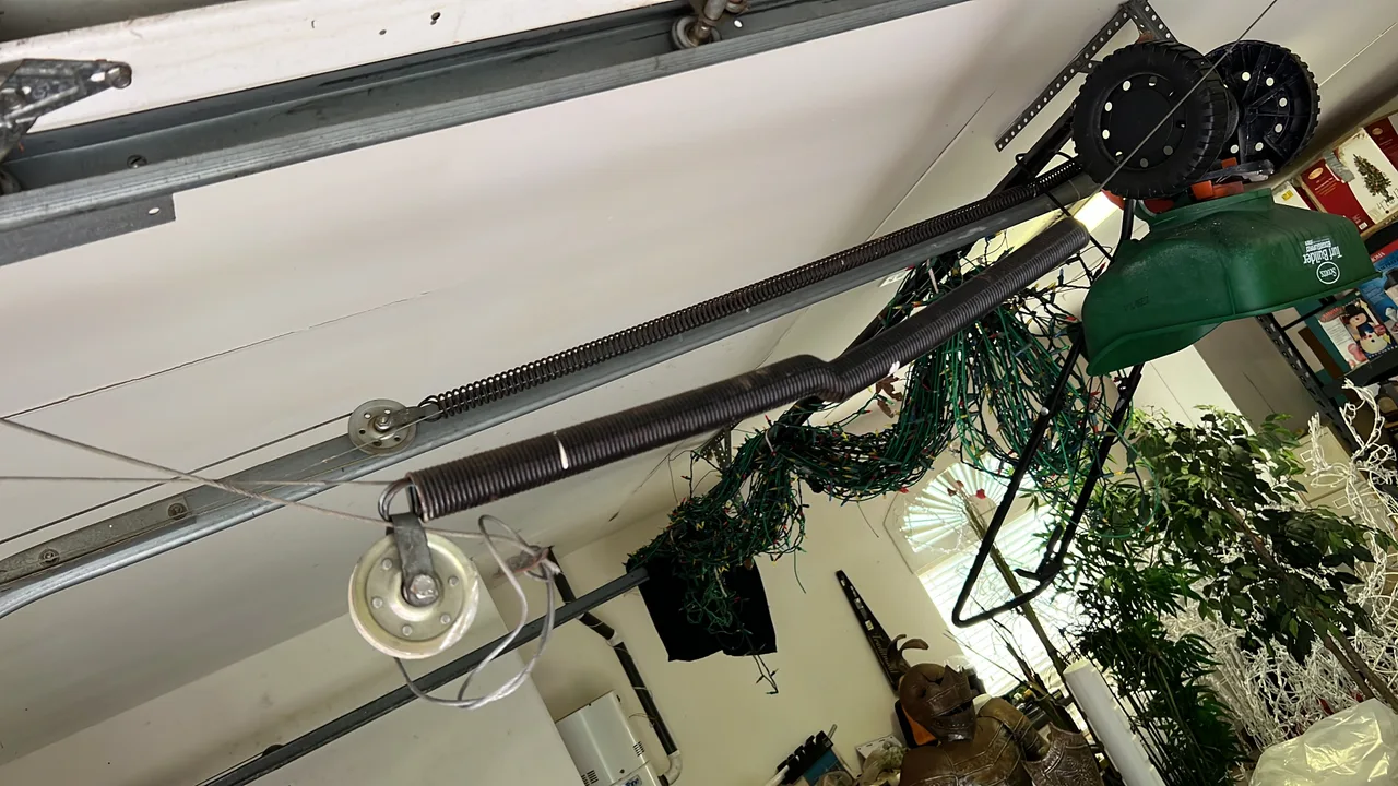 Extension springs and pulleys beside a garage door track
